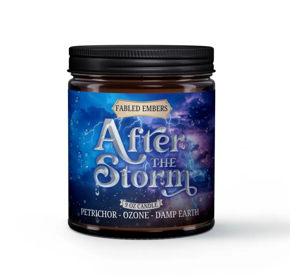 A candle in a glass jar with a thunderstorm background on the label. After the Storm is written on the label, as are the scent notes of petrichor, ozone, and damp earth, and the brand name Fabled Embers.